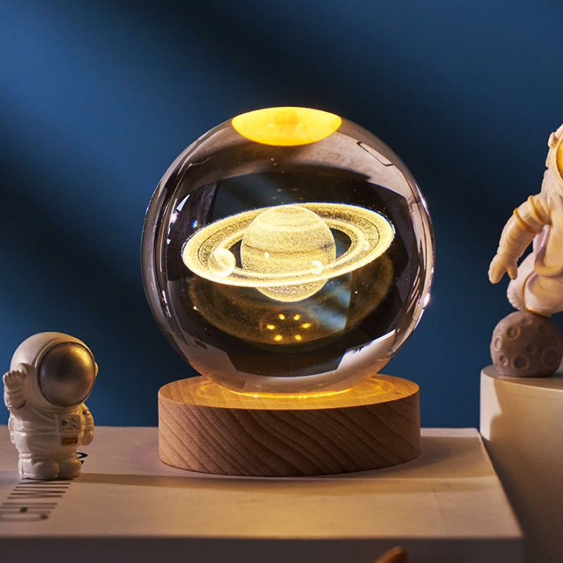 Lavisa 3D Crystal Ball Lamp glowing on a wooden base with a celestial galaxy design (View 6)