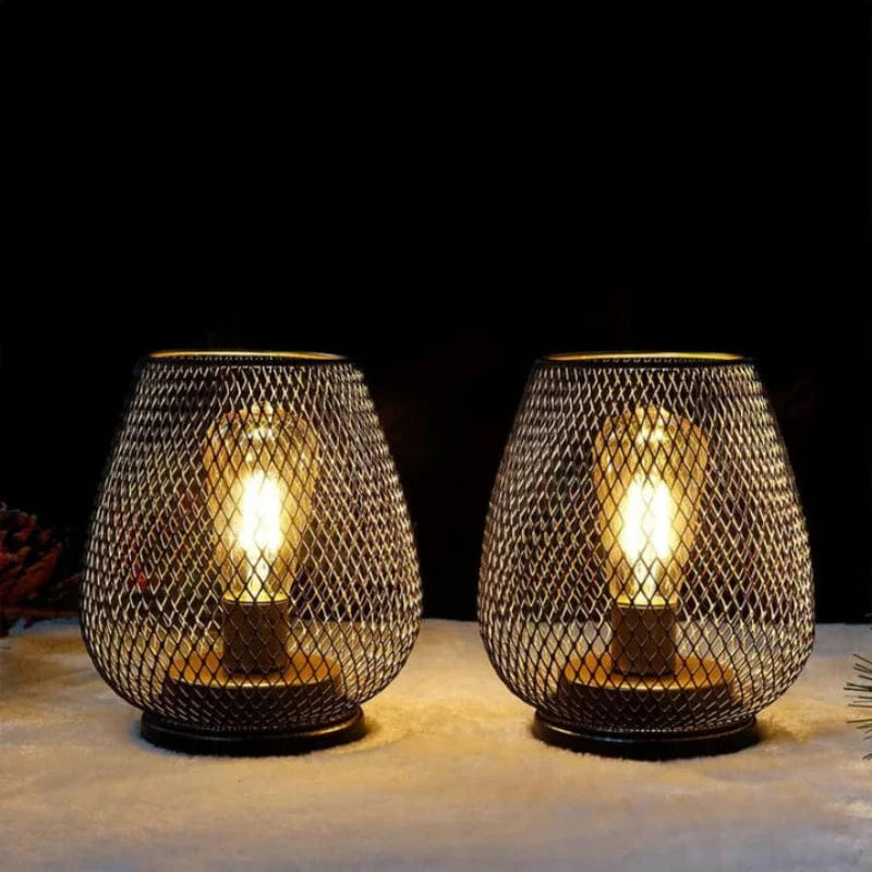 Lavisa Dimmable LED Metal Lantern Set glowing warmly on an outdoor wooden table (View 8)