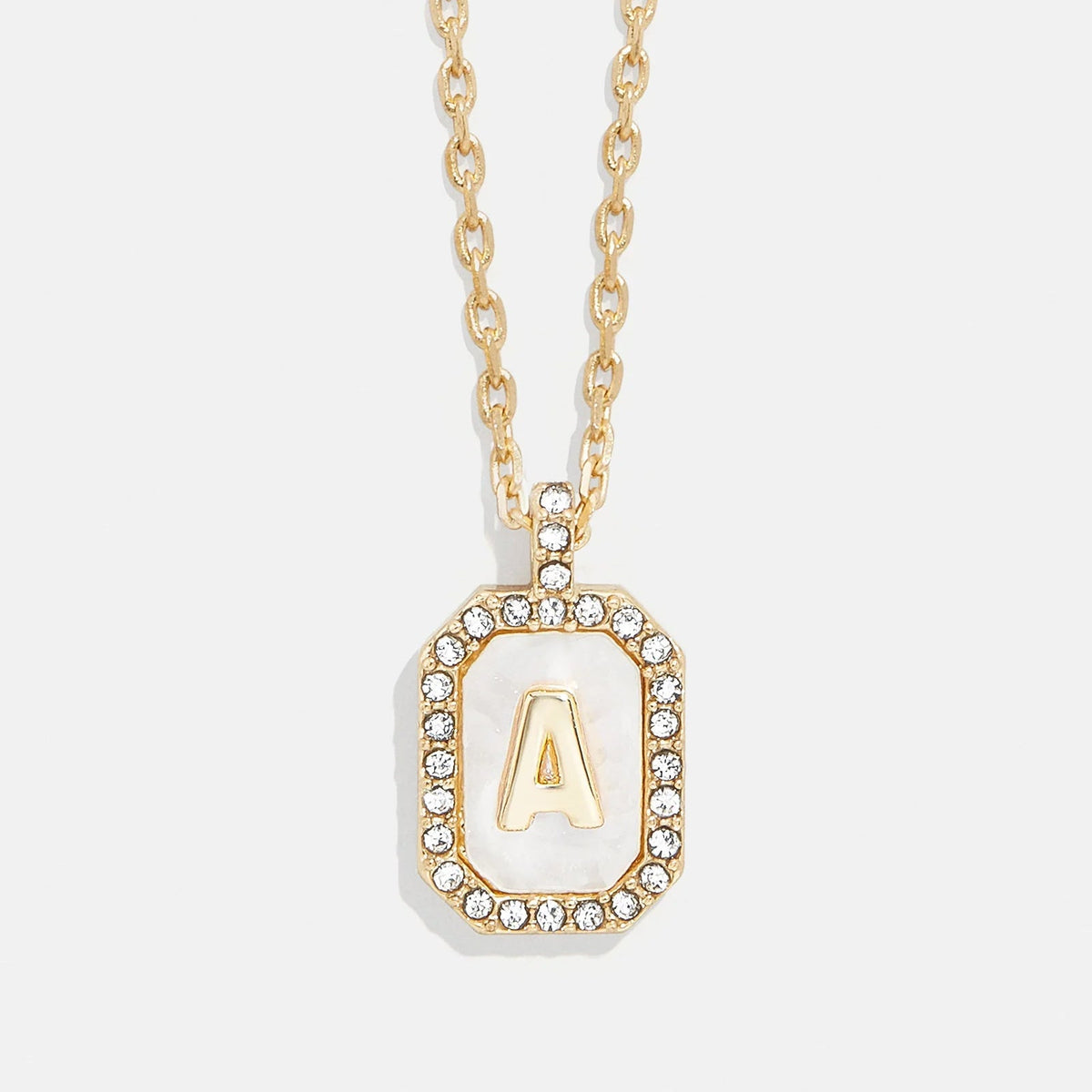 Lavisa Gold and Mother of Pearl Initial Necklace featuring a custom letter on a dog tag pendant