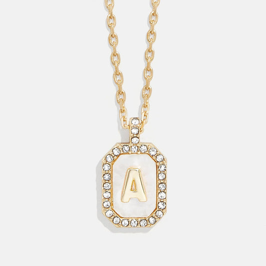 Lavisa Gold and Mother of Pearl Initial Necklace featuring a custom letter on a dog tag pendant