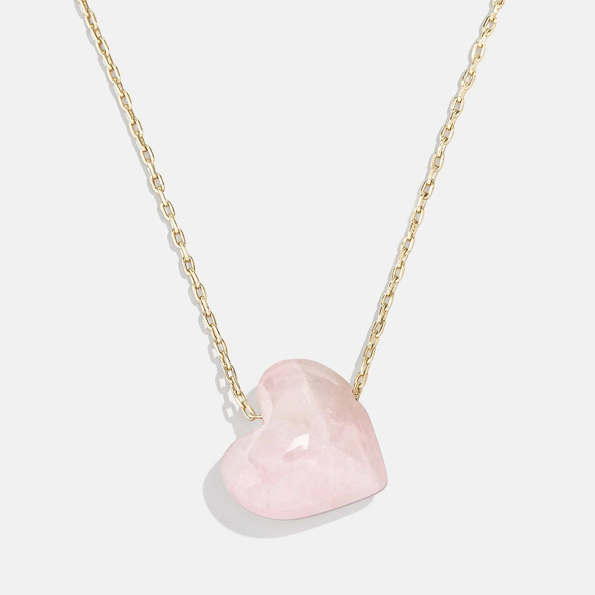 Lavisa Rose Quartz Heart Necklace featuring a natural pink crystal heart pendant on a gold chain