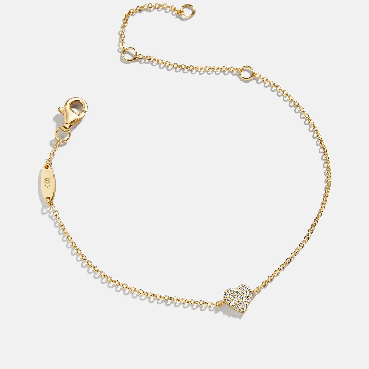 Lavisa 18K gold dainty heart pendant bracelet displayed on a soft surface