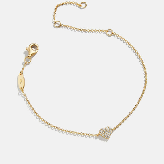 Lavisa 18K gold dainty heart pendant bracelet displayed on a soft surface