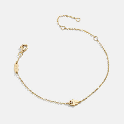 Lavisa 18K Gold Hamsa Protection Bracelet with a petite hamsa pendant and cubic zirconia.