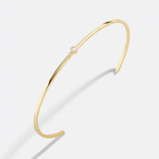 Lavisa 18K gold cuff bracelet with center stone on a clean background