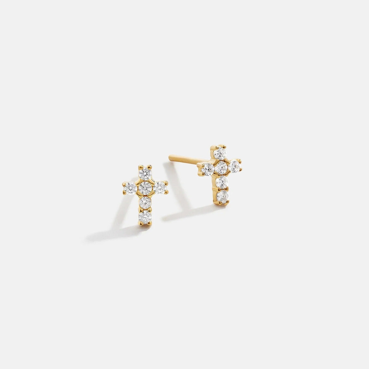 Lavisa 14K gold pavé cross earrings sparkling on display