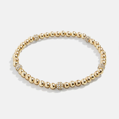 Lavisa Gold Beaded Pavé Sphere Stretch Bracelet featuring mixed gold beads and sparkling accents.