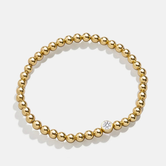 Lavisa 18K Gold Birthstone Beaded Bracelet featuring 4mm gold beads and a crystal accent.