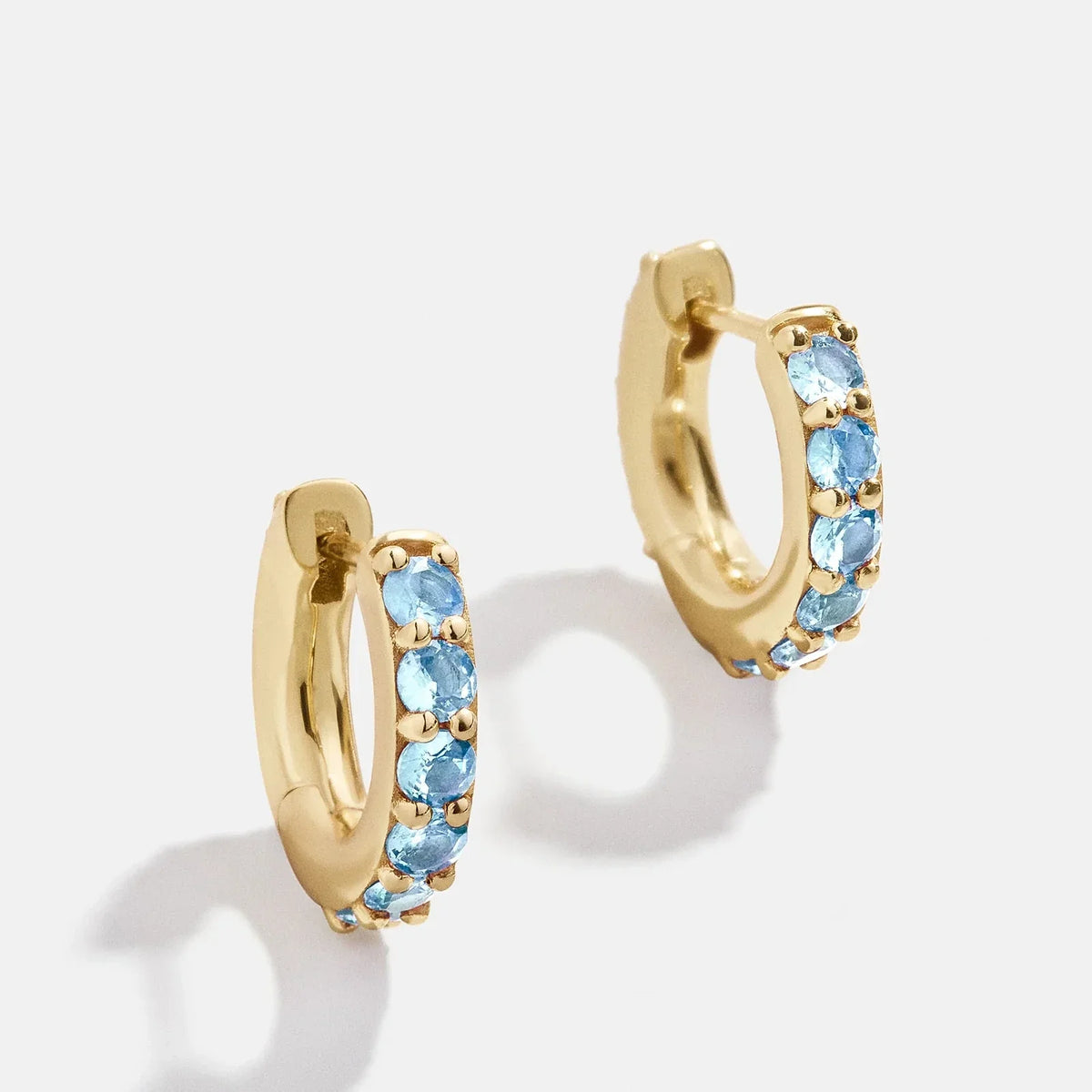 Lavisa 18K gold birthstone huggie earrings with cubic zirconia stones