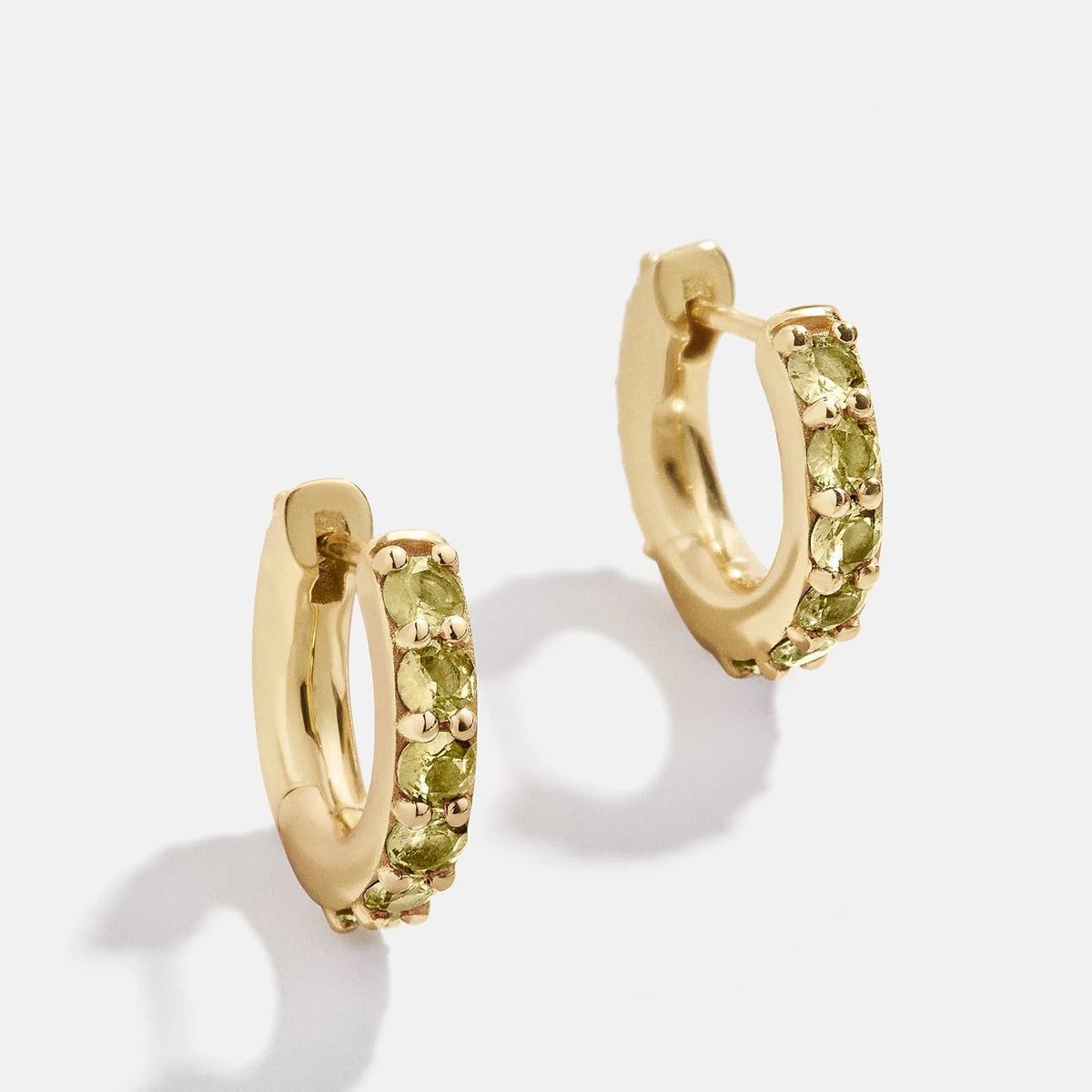 Lavisa 18K Gold Birthstone Huggie Earrings featuring shimmering green peridot stones