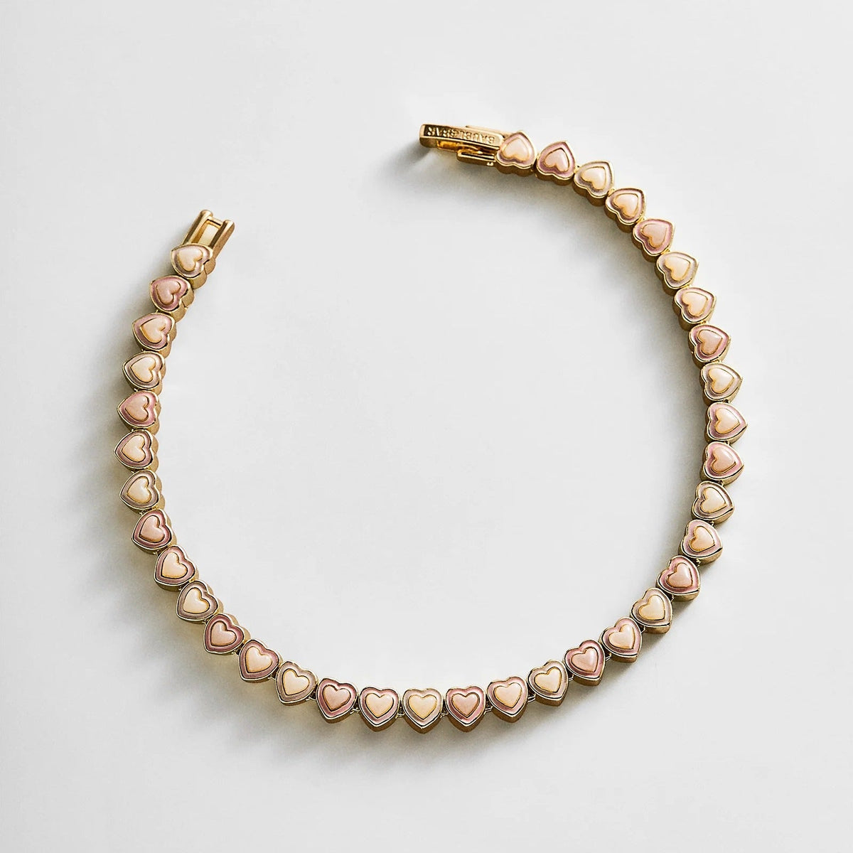 Lavisa pastel pink heart tennis bracelet on a soft background