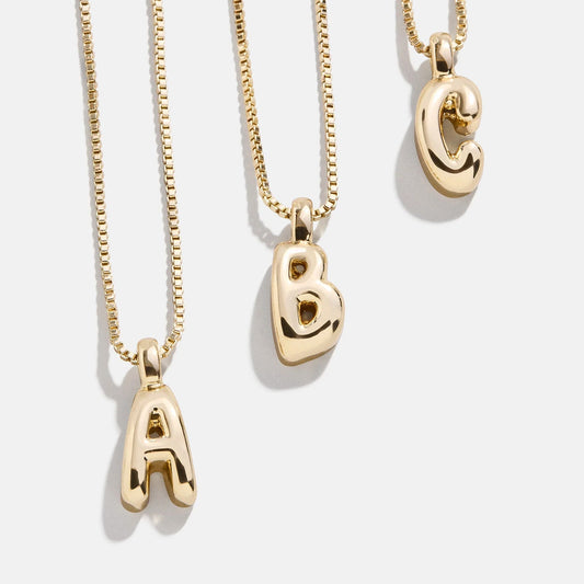 Lavisa Gwen mini bubble initial gold necklace on a delicate chain.