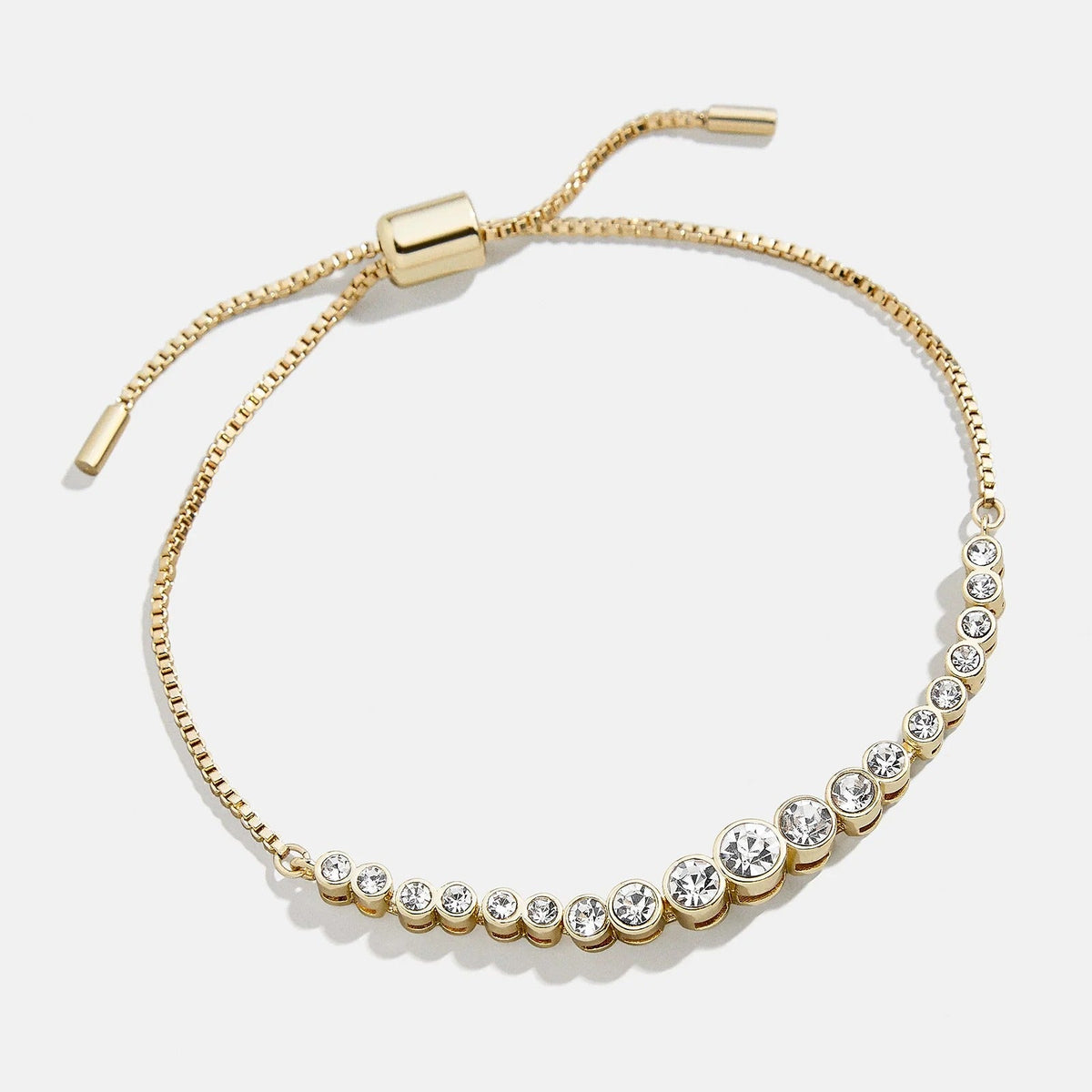Lavisa Pavé Crystal Pull Tie Tennis Bracelet in gold with sparkling bezel-set stones.
