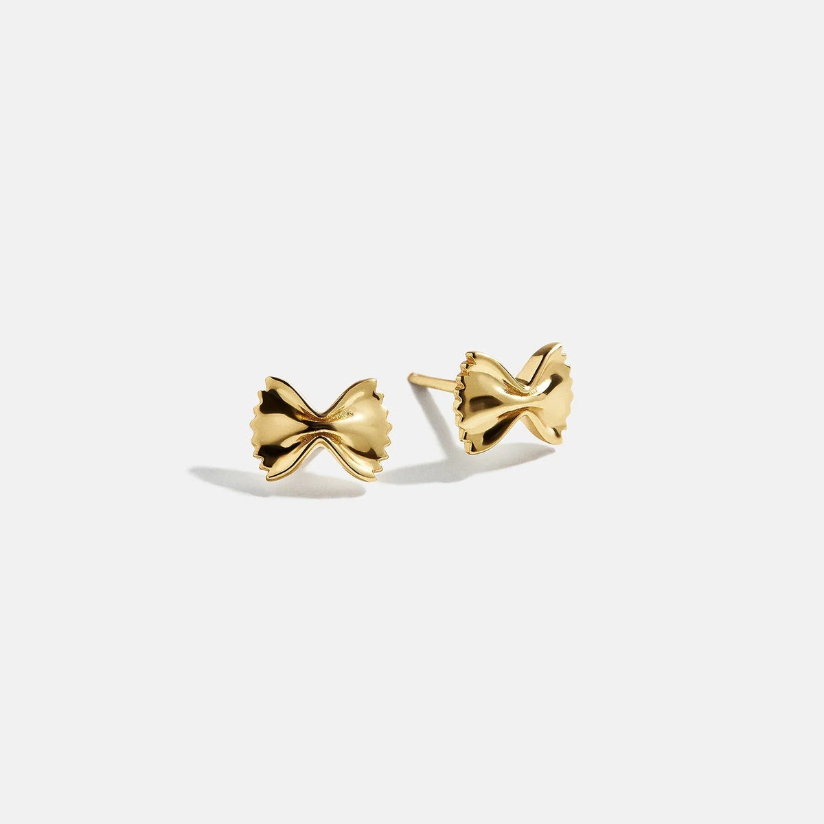 Lavisa 18K Gold bowtie pasta novelty stud earrings on display