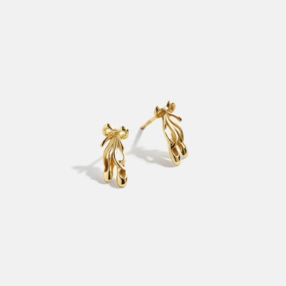 Lavisa delicate gold ballet shoe stud earrings on a clean background