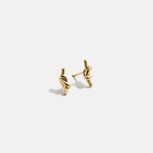 Lavisa minimalist gold knot stud earrings displayed on a clean surface