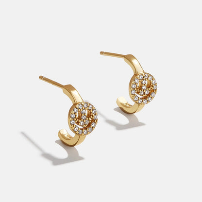 Lavisa pavé smiley face gold stud earrings sparkling under studio lights