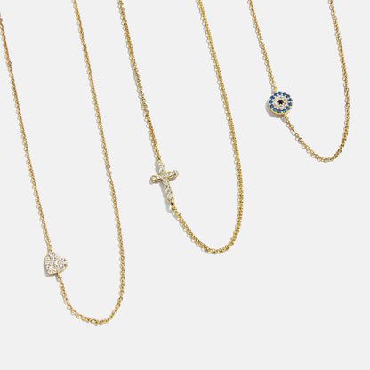 Lavisa 18K Gold Asymmetrical Cross Necklace with a sparkling cubic zirconia pendant