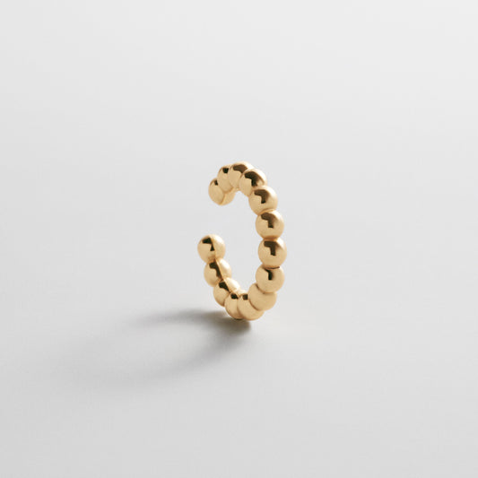 Lavisa 18K Gold Pisa Beaded Ear Cuff shown as a minimalist slip-on accessory