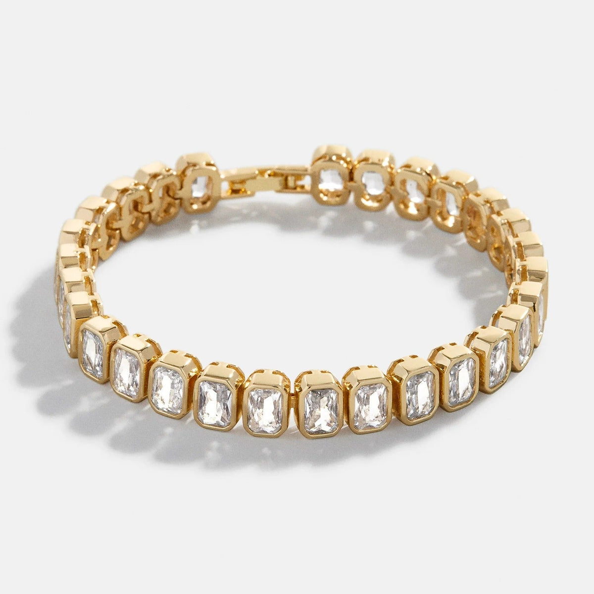 Lavisa emerald cut bezel crystal tennis bracelet shining on a display pad