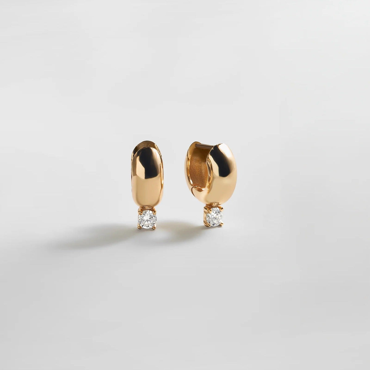 Lavisa Glossy Gold Huggie Earrings with Round Stone Accent
