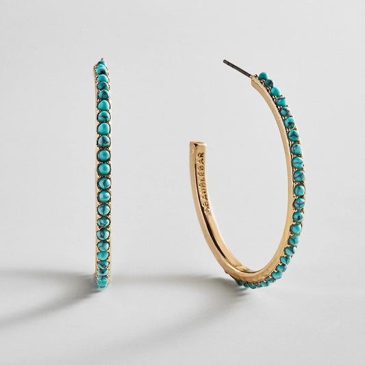 Lavisa gold and turquoise semi-precious statement hoop earrings on display