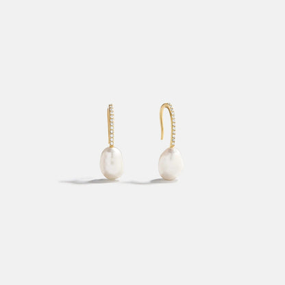 Lavisa gold pearl drop earrings with pavé hook on a neutral background