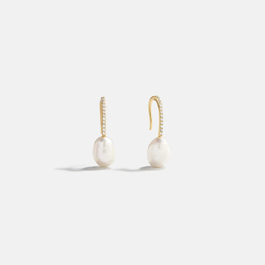 Lavisa gold pearl drop earrings with pavé hook on a neutral background