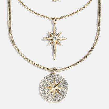 Lavisa Lyra celestial layered necklace featuring gold chains and star pendants.