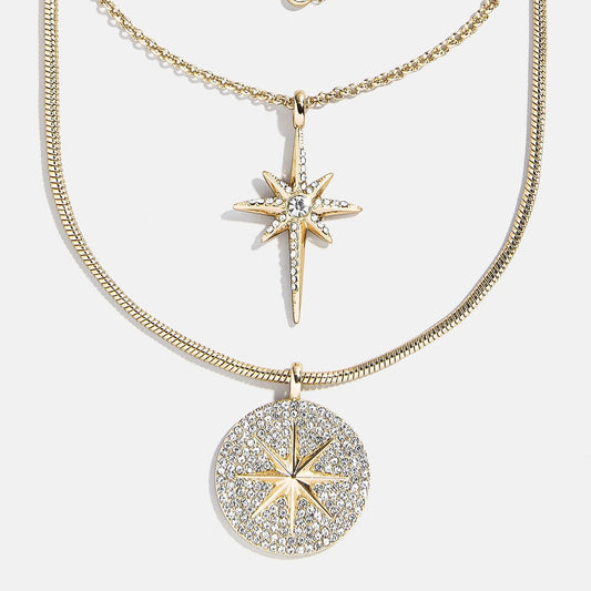 Lavisa Lyra celestial layered necklace featuring gold chains and star pendants.