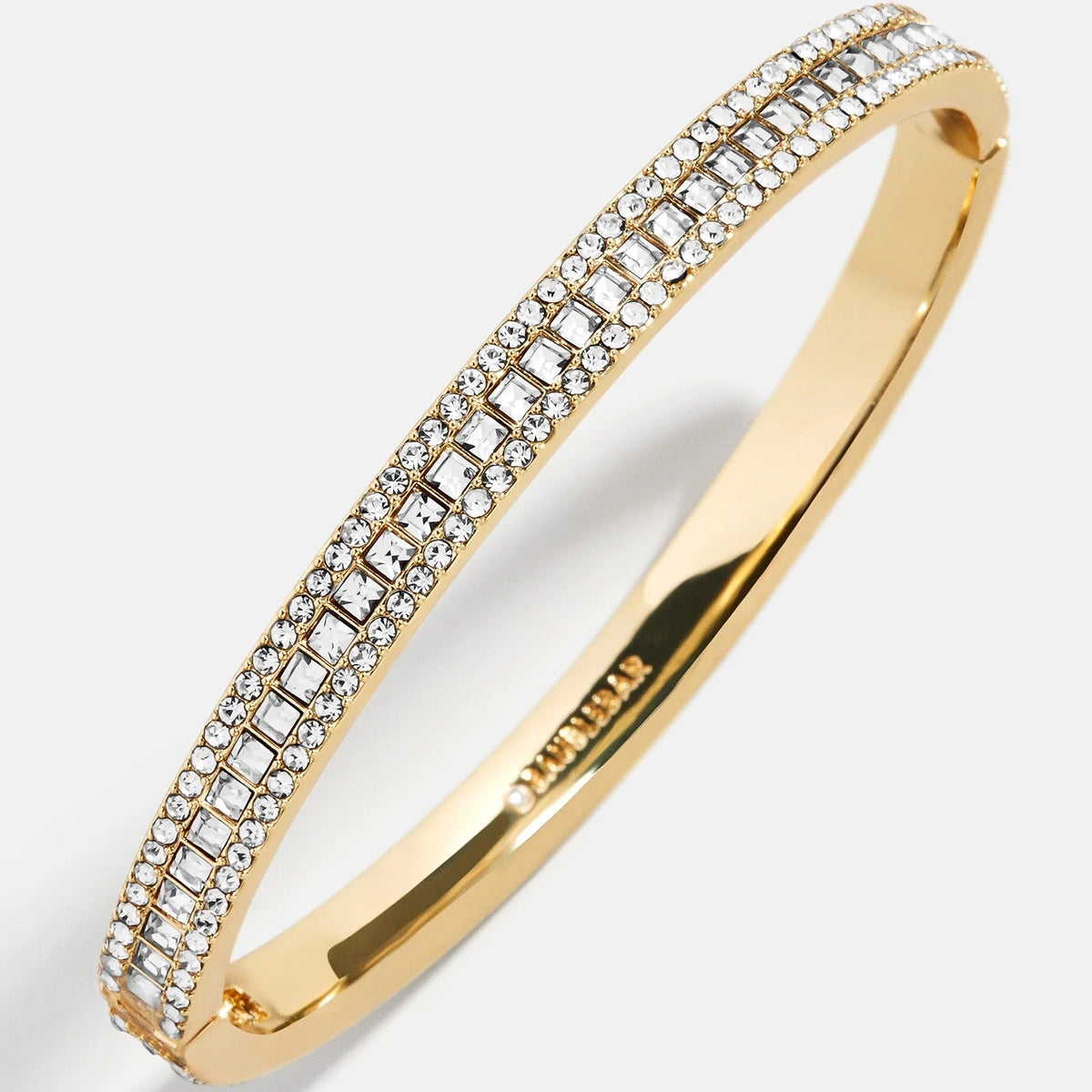 Lavisa Triple Row Crystal Hinge Bangle featuring three rows of bright crystals in gold.