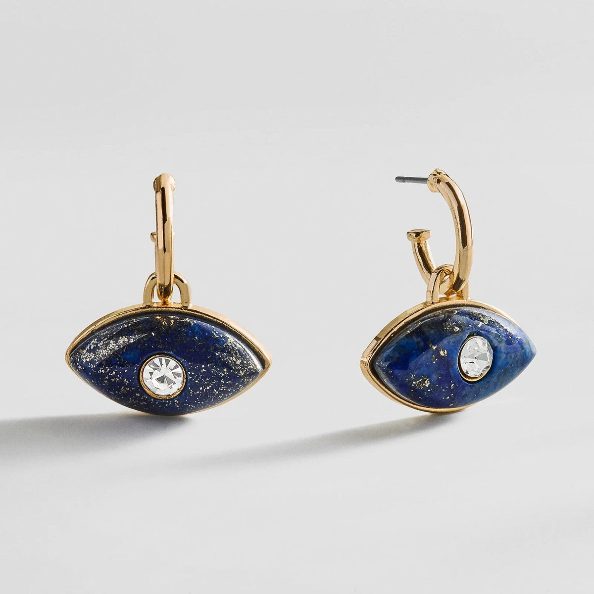 Lavisa Evil Eye Huggie Earrings in gold with blue sodalite charms