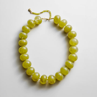 Lavisa oversized statement beaded necklace featuring colorful resin and olive beads.