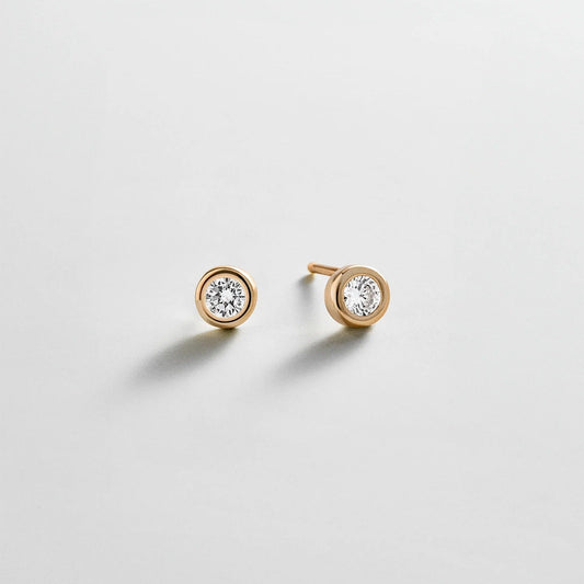 Lavisa gold stud earrings featuring a round crystal stone in a sleek bezel setting