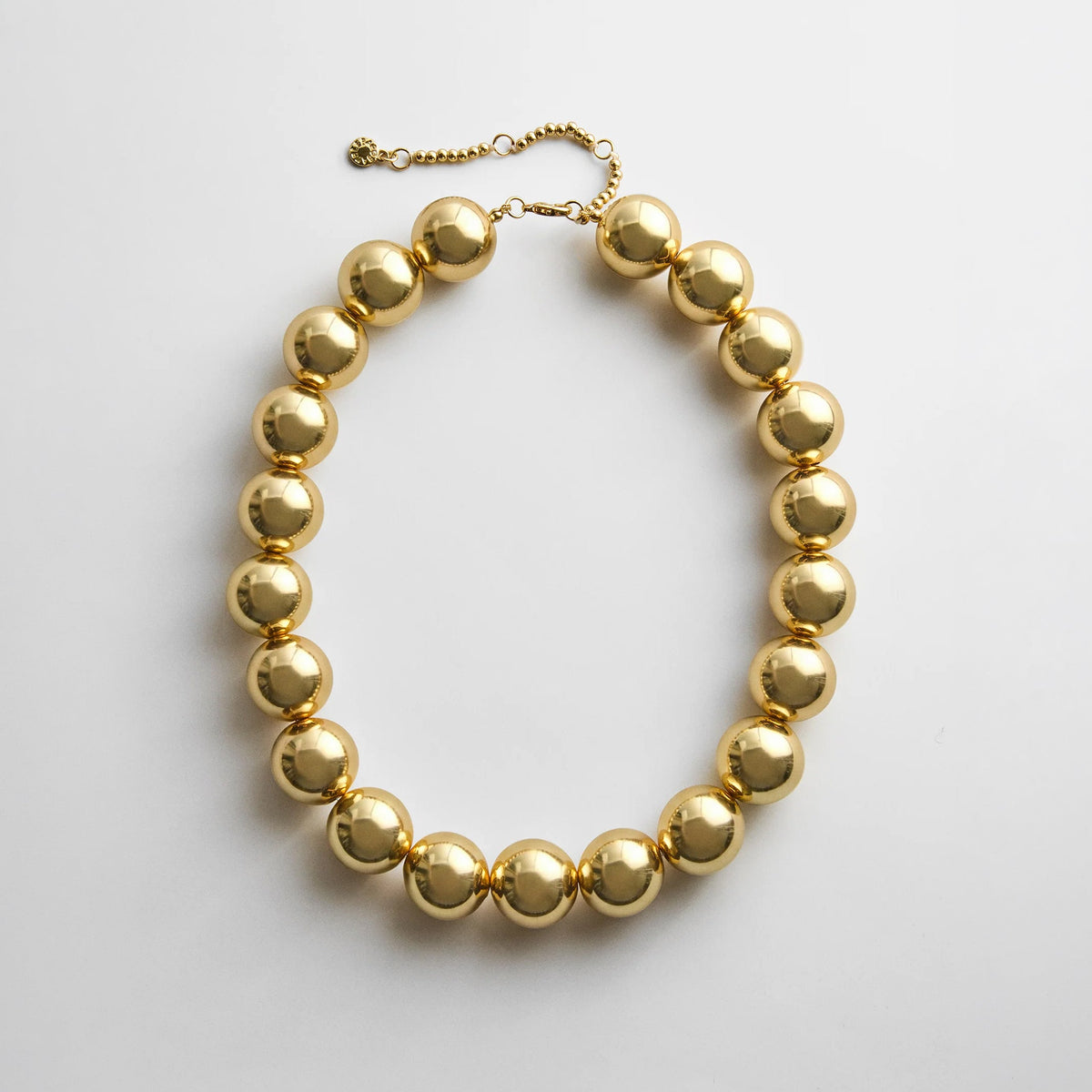 Lavisa chunky gold beaded statement necklace on a white background