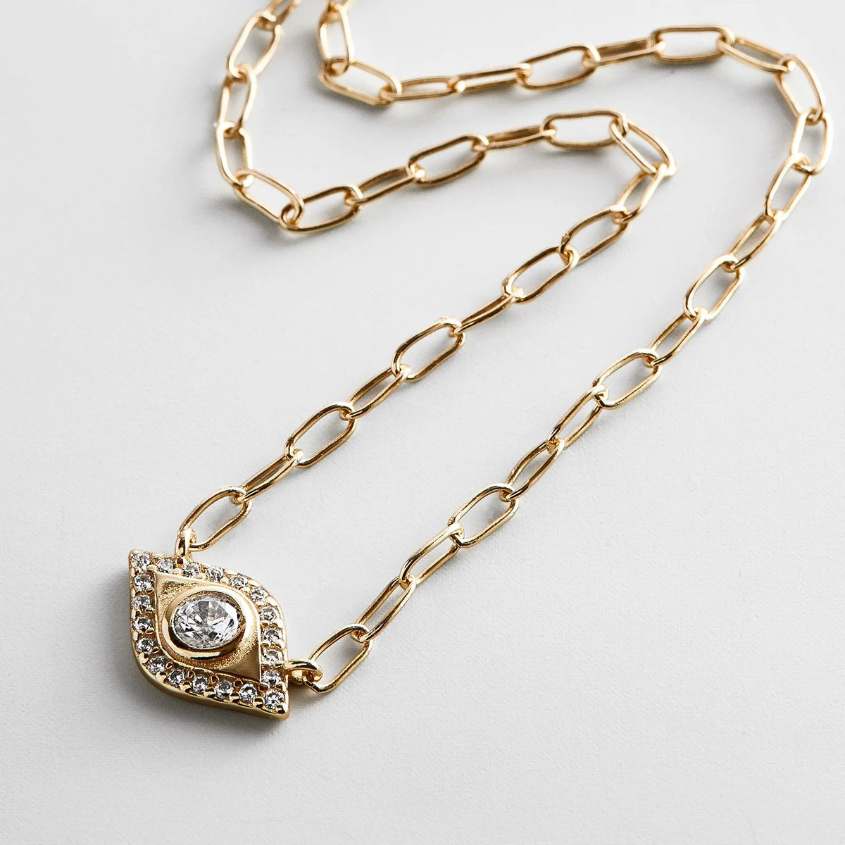Lavisa 14K Gold Evil Eye Charm Necklace featuring a delicate protective pendant with pavé stones.