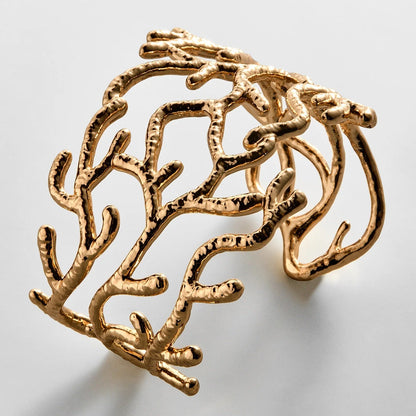 Lavisa gold coral-inspired hammered cuff bracelet on display