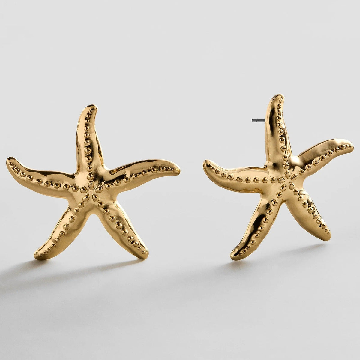 Lavisa oversized gold starfish statement earrings with realistic textured detailing