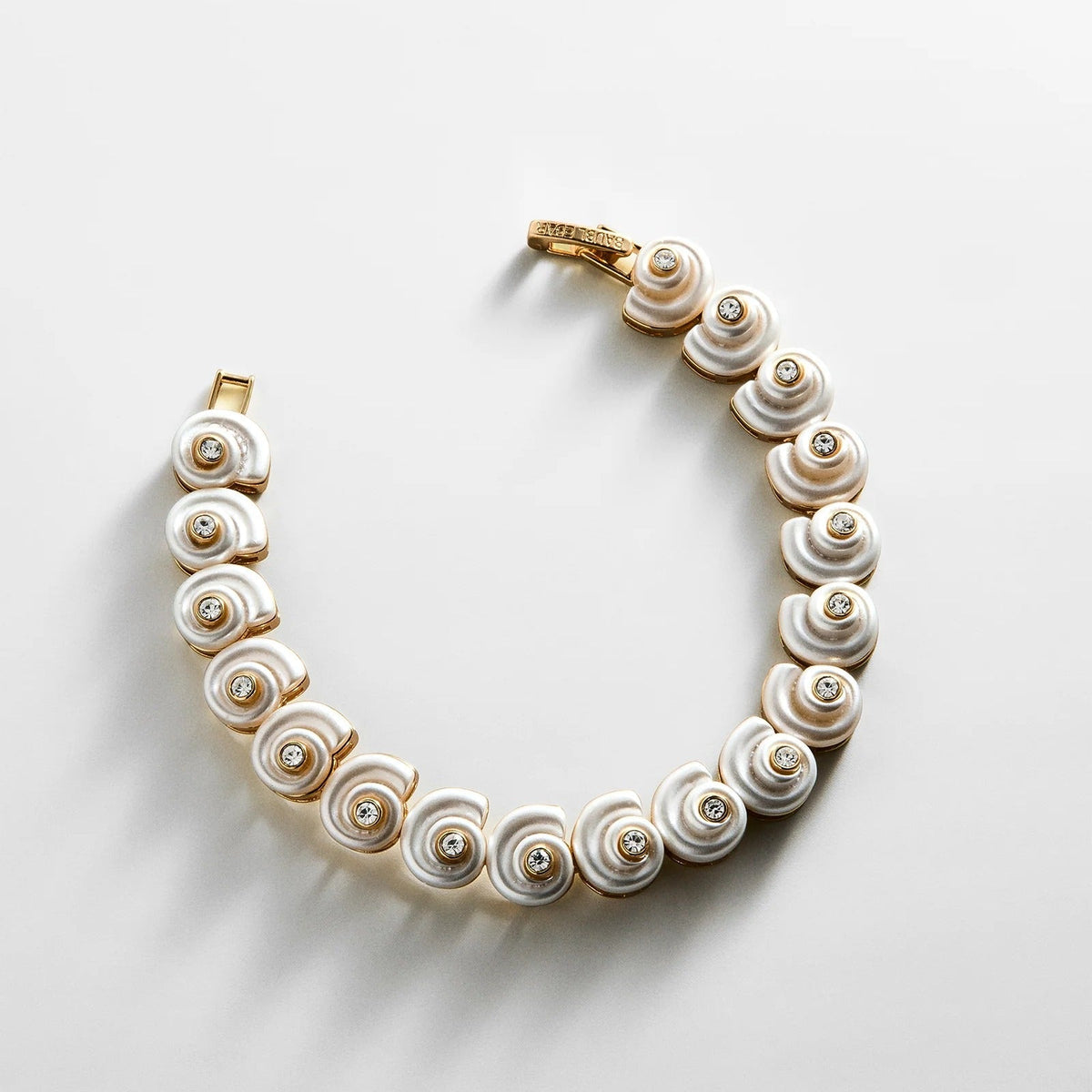 Lavisa gold shell tennis bracelet with iridescent resin shells and gemstone accents