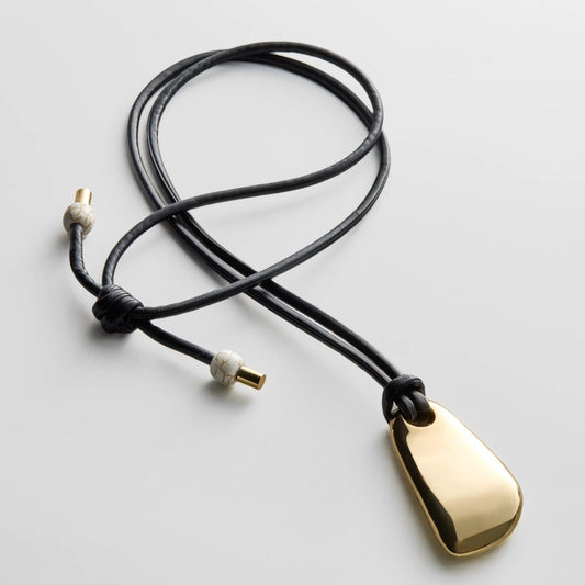 Lavisa sculptural gold pendant necklace on adjustable black cord