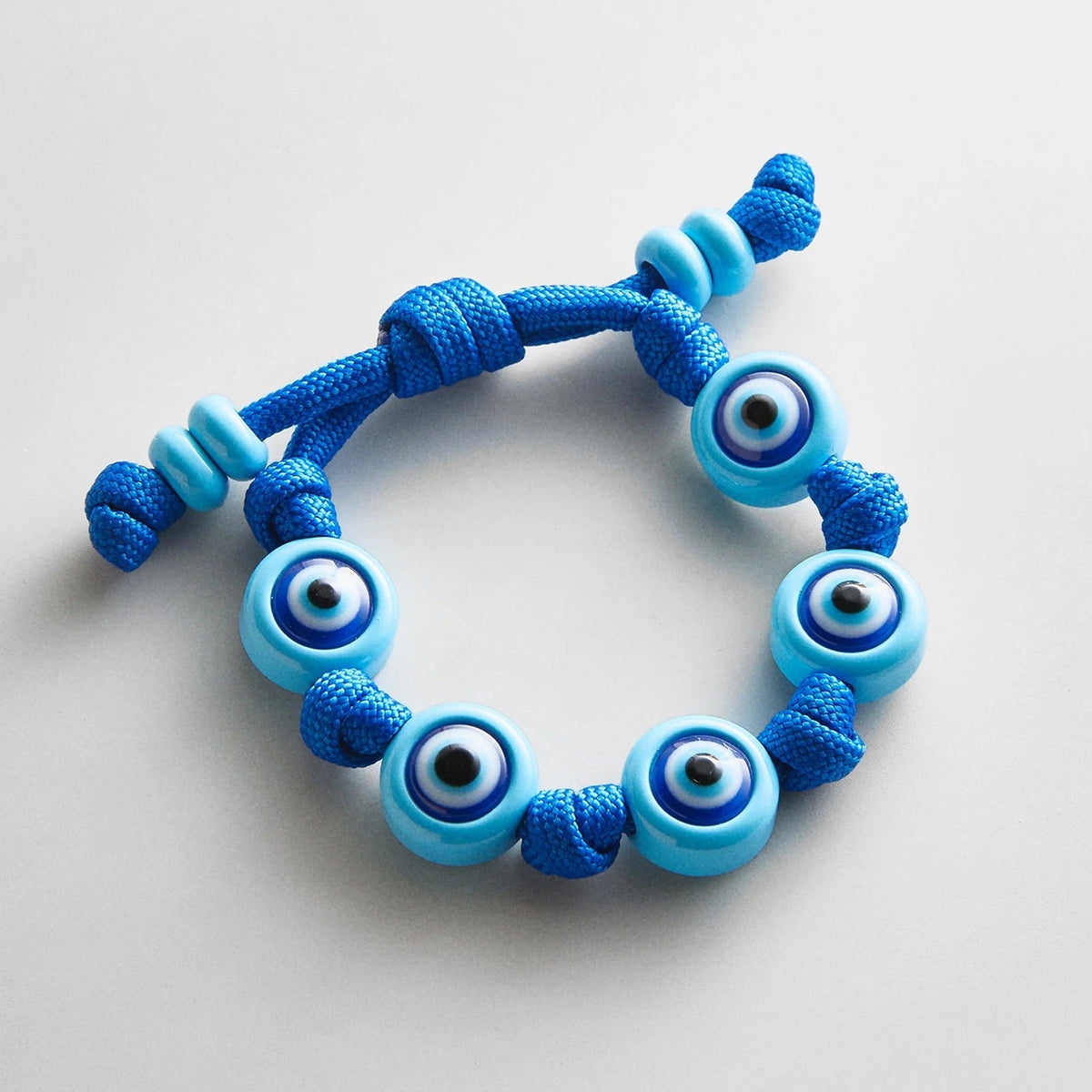 Lavisa knotted cord evil eye bracelet with glossy enamel charms and adjustable tie