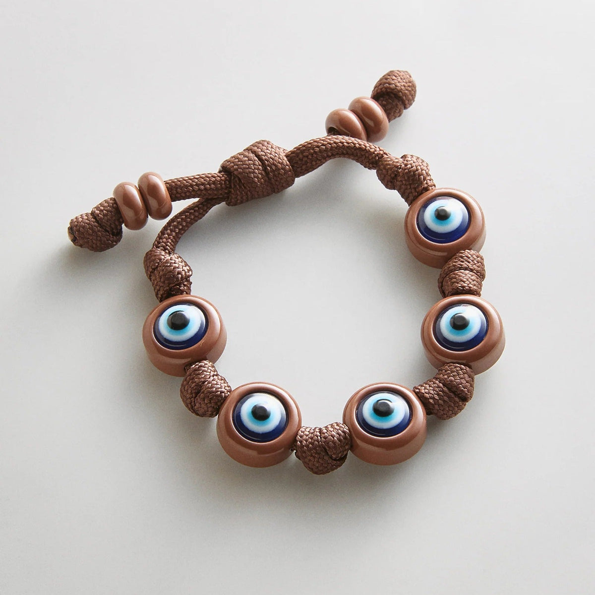 Lavisa chocolate brown knotty cord bracelet featuring vibrant evil eye beads