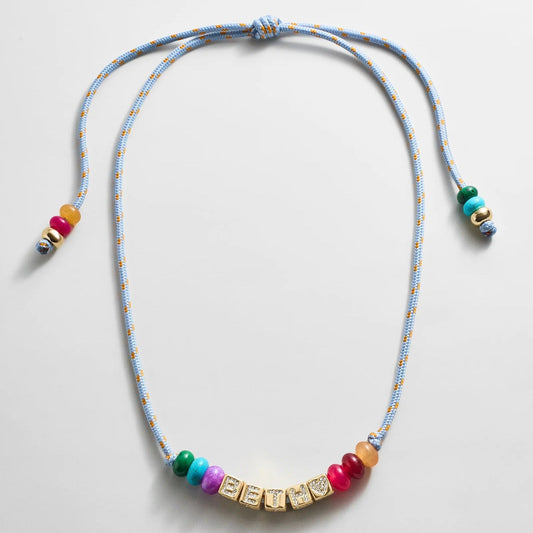 Lavisa custom block letter necklace with semi-precious beads on a blue paracord