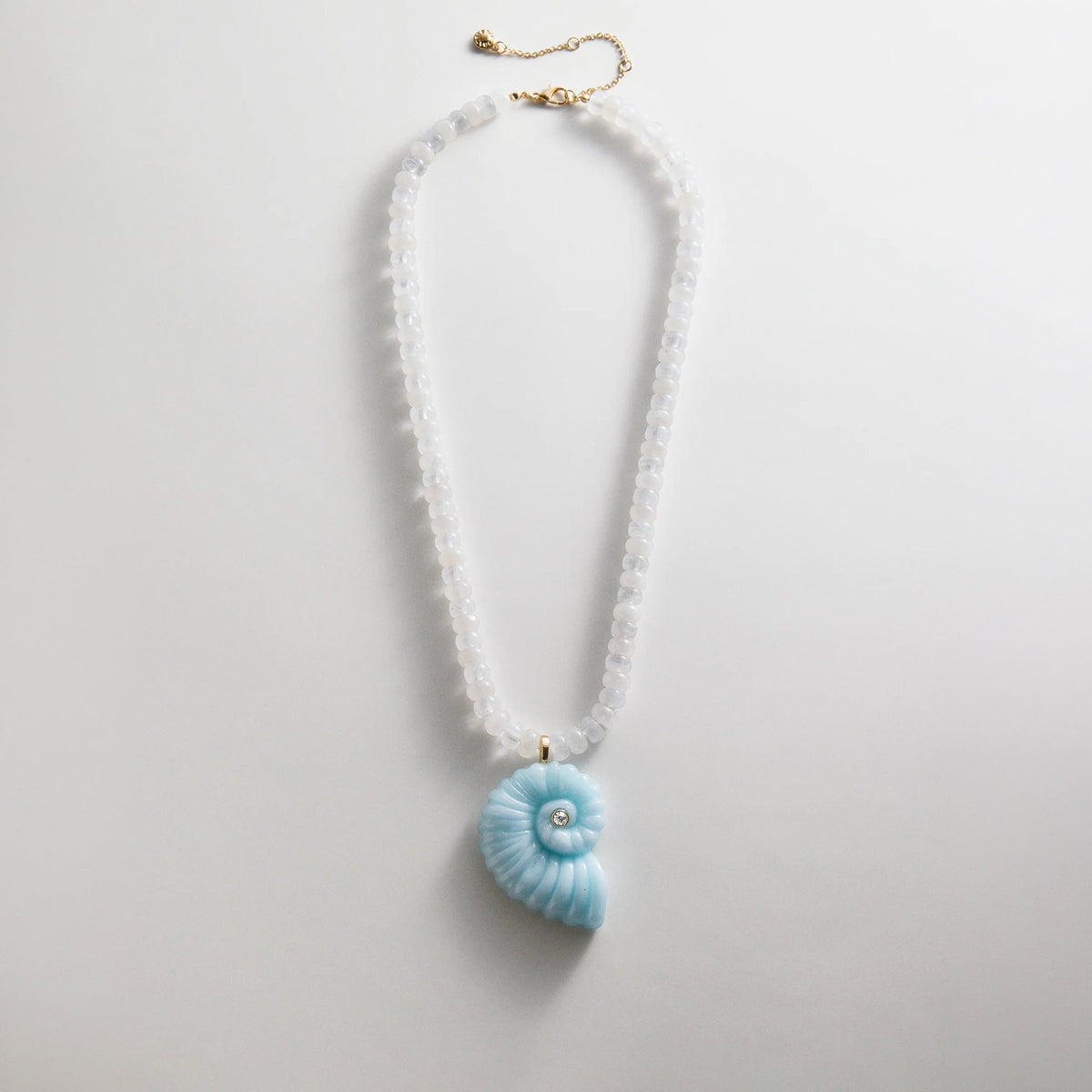 Lavisa Semi-Precious Shell Pendant Necklace featuring a blue spiral shell and white quartz beads