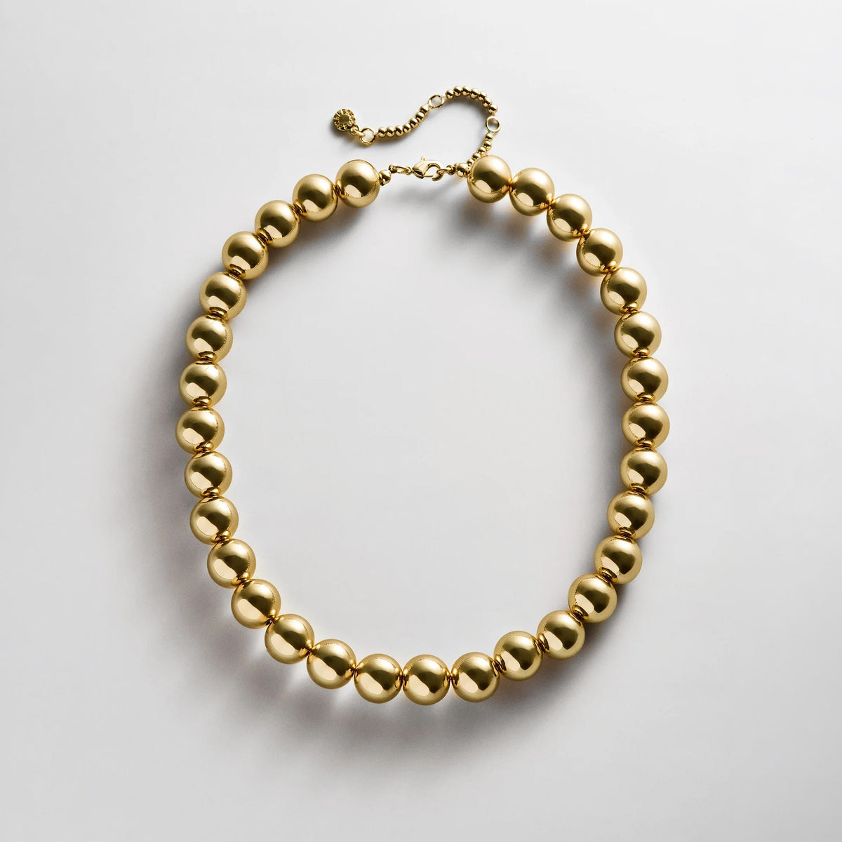 Lavisa gold beaded necklace featuring glossy 14mm resin beads for layering