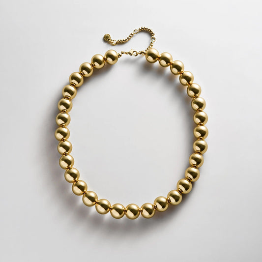 Lavisa gold beaded necklace featuring glossy 14mm resin beads for layering