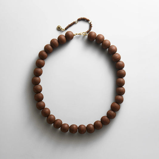 Lavisa dark wood beaded statement necklace displayed on a neutral background