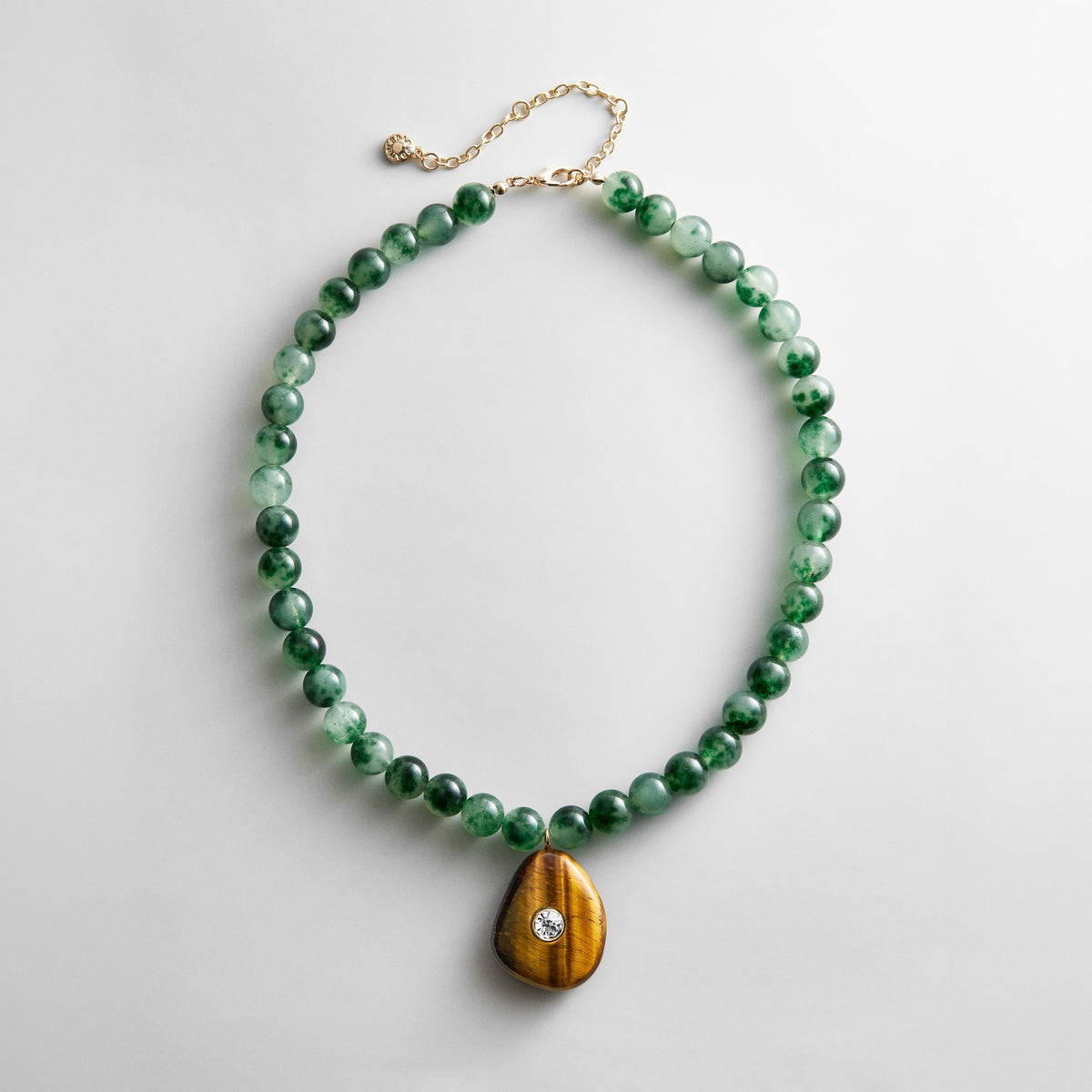 Lavisa semi-precious jade and tiger's eye necklace with crystal pendant.