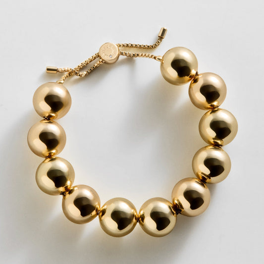 Lavisa gold beaded charm bracelet displayed for stylish wrist stacking