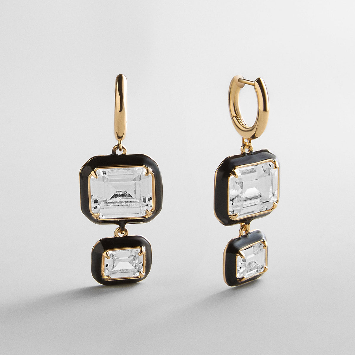 Lavisa crystal drop earrings featuring a bold black enamel bezel.